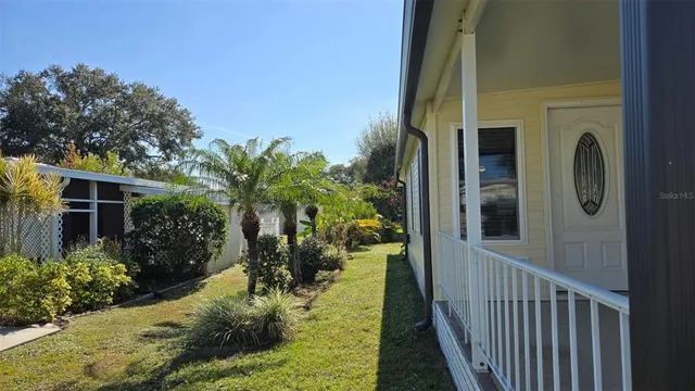 a view of a porch with plants and trees