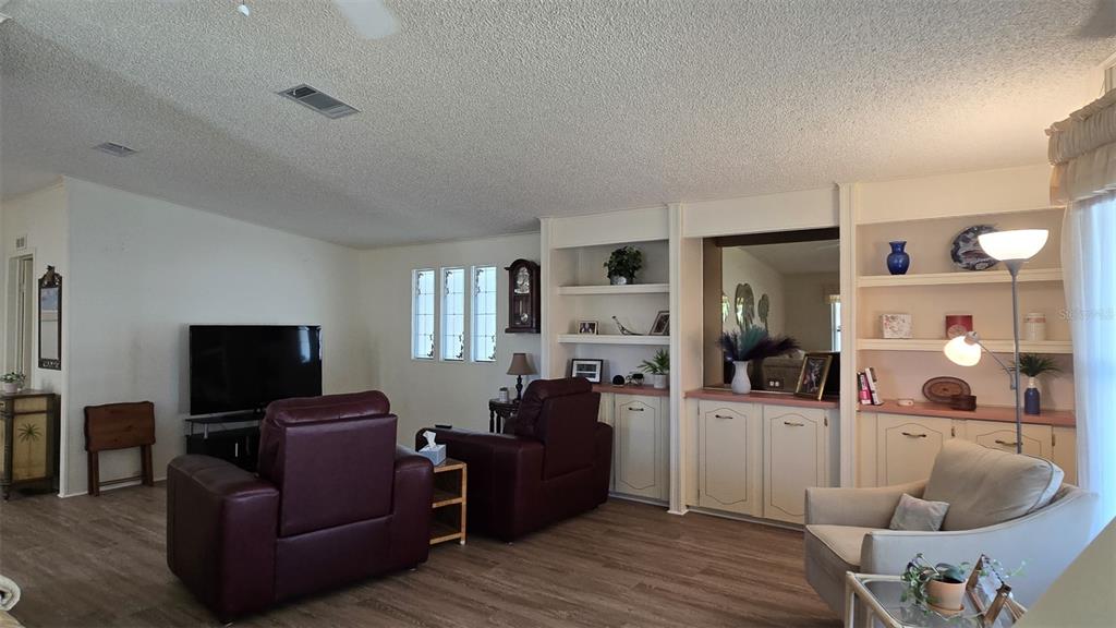 927 Yew Street Sebastian, FL 32976 - Photo 7 of 49 a living room with furniture window and a flat screen tv