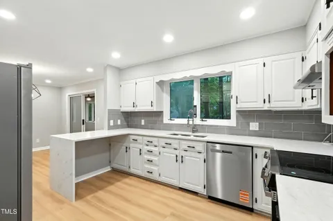 a kitchen with a sink cabinets and window