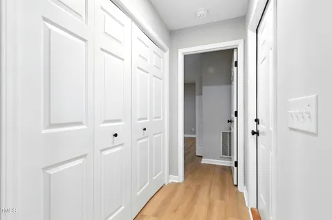 a view of a hallway with wooden floor
