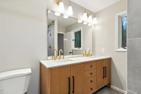 a bathroom with a double vanity sink and a mirror