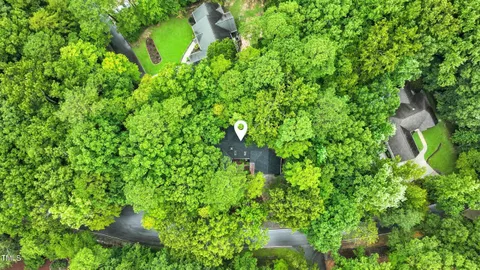 a backyard of a house with lots of green space and garden