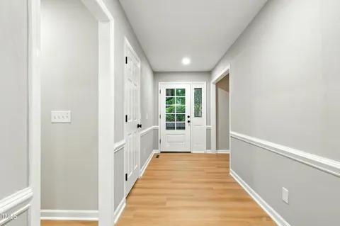 a view of a hallway with wooden floor