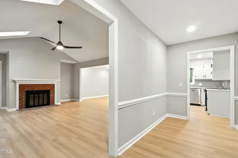 a view of a kitchen with wooden floor and a ceiling fan