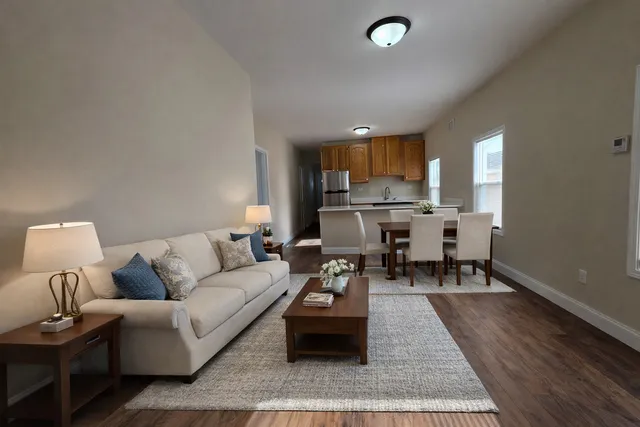 a living room with furniture and a wooden floor