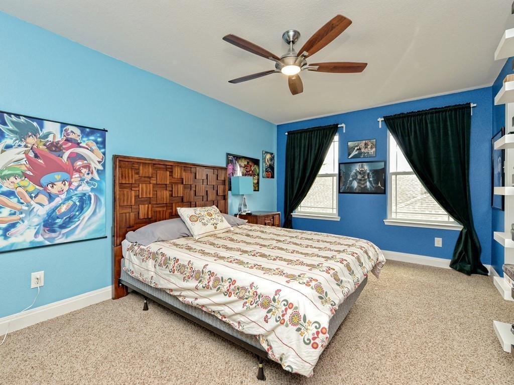 1067 Toltec Trail Georgetown, TX 78626 - Photo 20 of 30 Bedroom featuring carpet and a ceiling fan