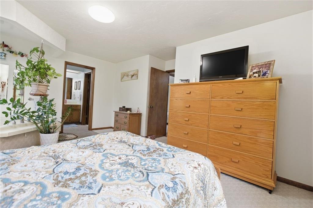 873 Linden Road Eighty Four, PA 15330 - Photo 28 of 40 a bedroom with a bed and a flat screen tv