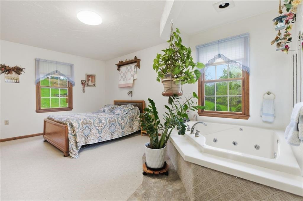 873 Linden Road Eighty Four, PA 15330 - Photo 29 of 40 a bedroom with a bed and a potted plant
