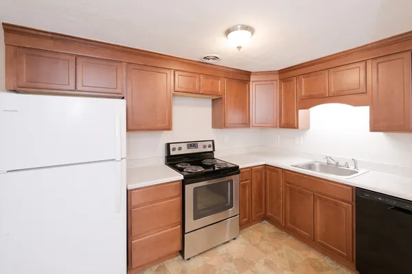 a kitchen with a sink a stove and refrigerator