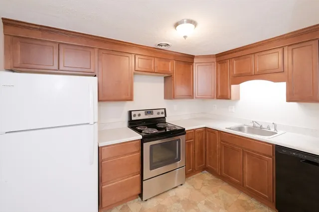 a kitchen with a sink a stove and refrigerator