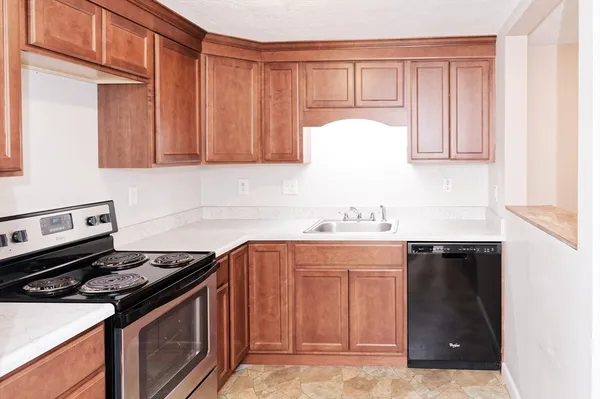 a kitchen with a sink stove and cabinets