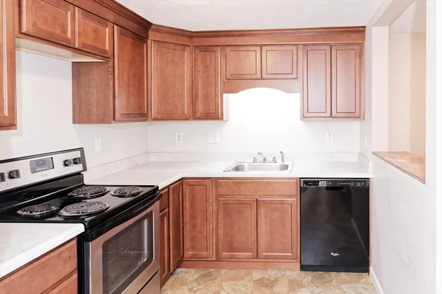 a kitchen with a sink stove and cabinets