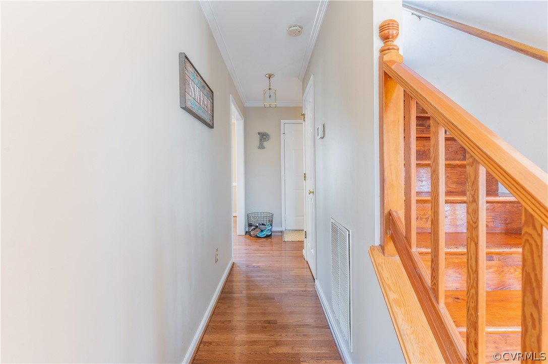 7607 Genuine Risk Lane Midlothian, VA 23112 - Photo 16 of 48 a view of a hallway with wooden floor and staircase
