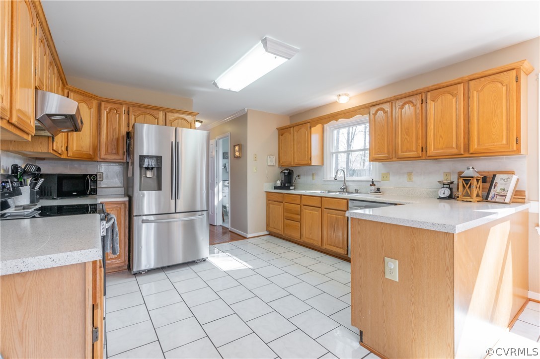 7607 Genuine Risk Lane Midlothian, VA 23112 - Photo 20 of 48 a kitchen with a sink a refrigerator and cabinets