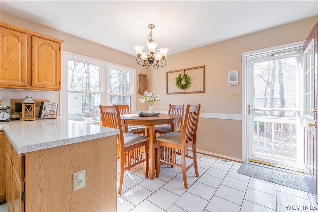 7607 Genuine Risk Lane Midlothian, VA 23112 - Photo 22 of 48 a dining room with furniture a window and kitchen view