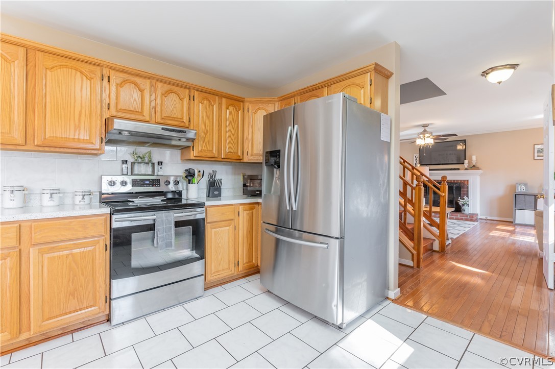 7607 Genuine Risk Lane Midlothian, VA 23112 - Photo 25 of 48 a kitchen with stainless steel appliances granite countertop a refrigerator and a stove top oven