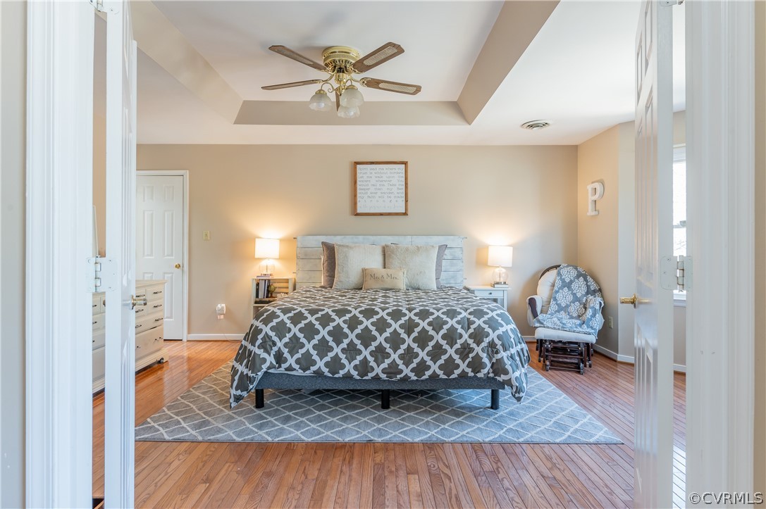 7607 Genuine Risk Lane Midlothian, VA 23112 - Photo 27 of 48 a bedroom with a bed and a chandelier
