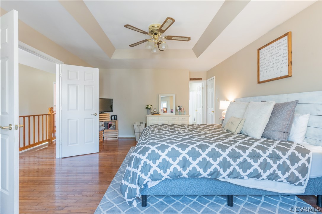 7607 Genuine Risk Lane Midlothian, VA 23112 - Photo 29 of 48 a bedroom with a large bed and a chandelier