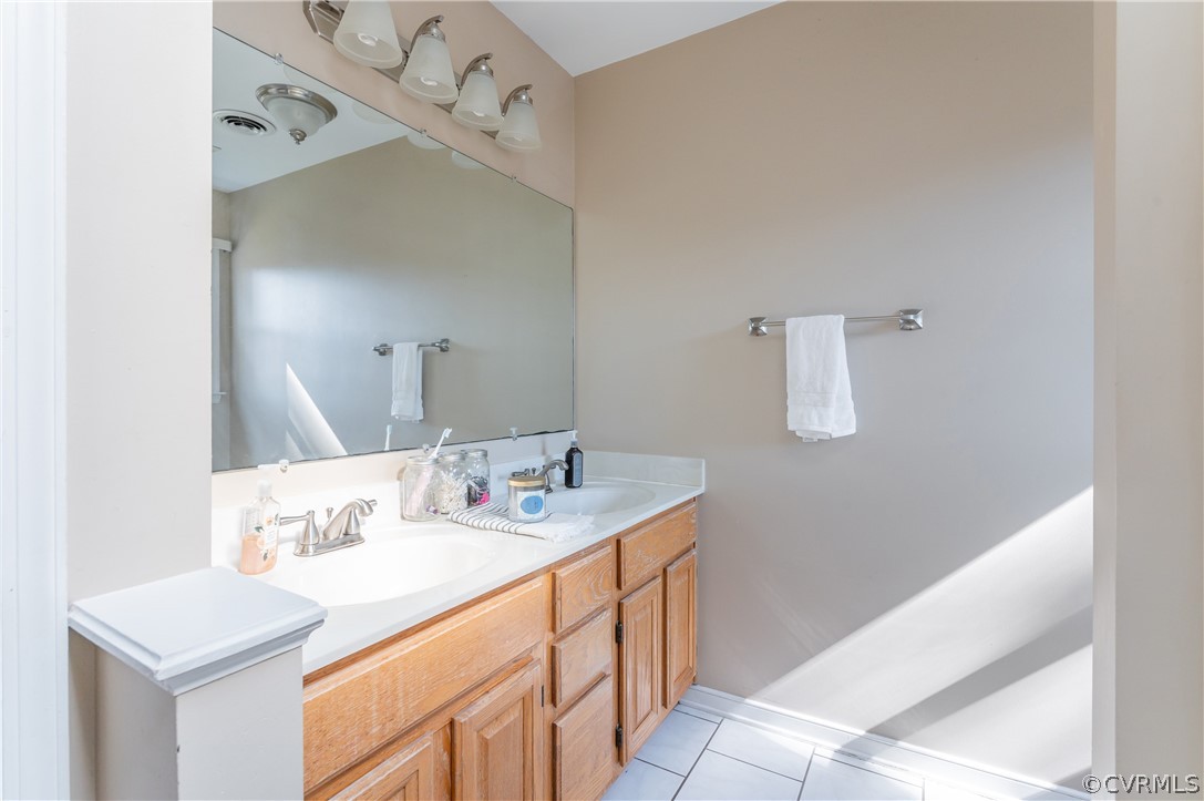 7607 Genuine Risk Lane Midlothian, VA 23112 - Photo 30 of 48 a bathroom with a sink and a mirror