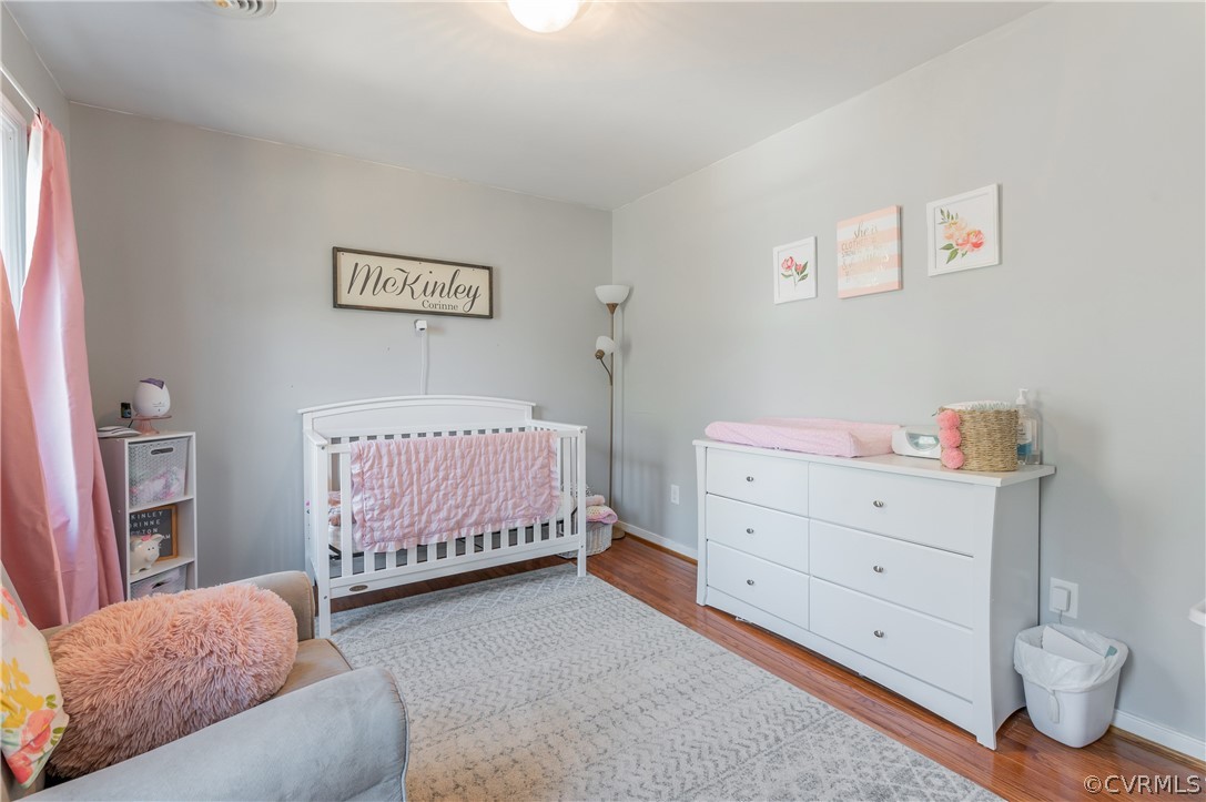 7607 Genuine Risk Lane Midlothian, VA 23112 - Photo 32 of 48 a bedroom with a baby bed and dresser