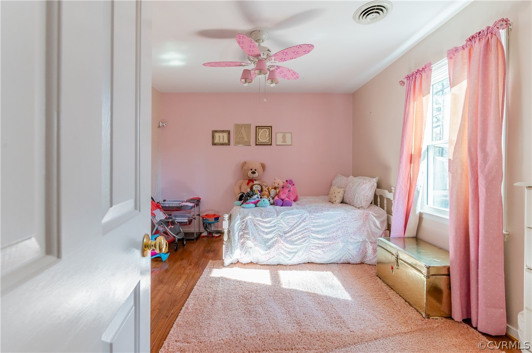 7607 Genuine Risk Lane Midlothian, VA 23112 - Photo 35 of 48 a bedroom with a bed and a chandelier