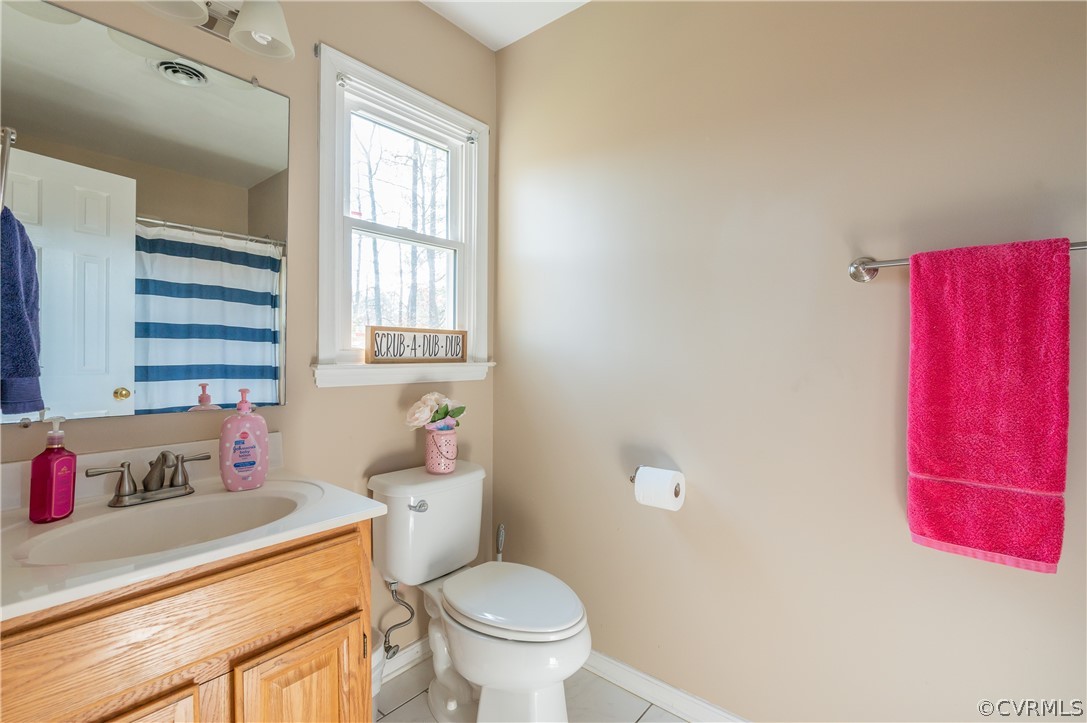 7607 Genuine Risk Lane Midlothian, VA 23112 - Photo 37 of 48 a bathroom with a sink toilet vanity and window