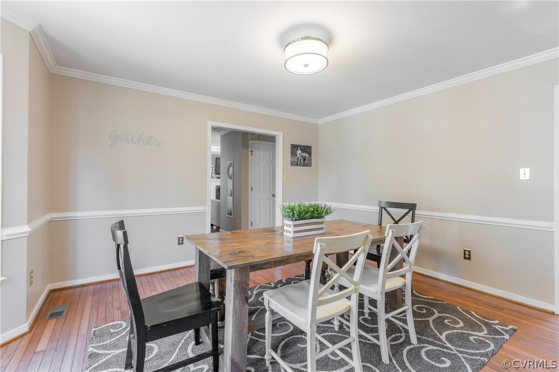 7607 Genuine Risk Lane Midlothian, VA 23112 - Photo 7 of 48 a view of a dining room with furniture and wooden floor