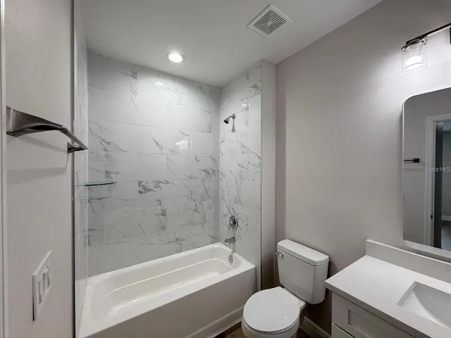 a bathroom with a toilet and a bathtub