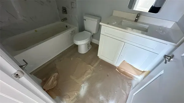 a bathroom with a sink a toilet and bathtub