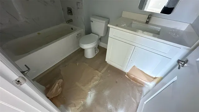 a bathroom with a sink a toilet and bathtub