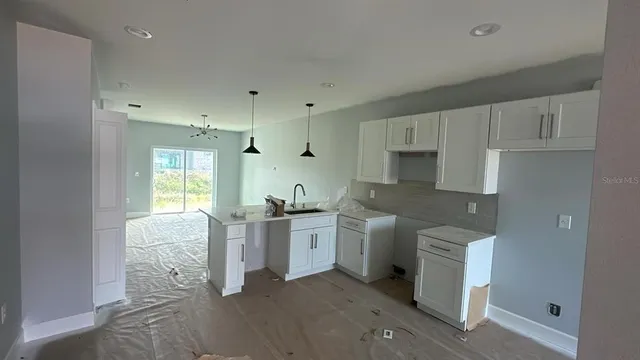 a kitchen with lot of cabinets and refrigerator