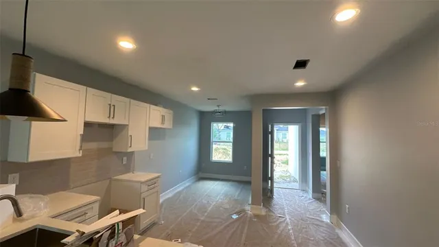 a view of a livingroom with furniture and staircase