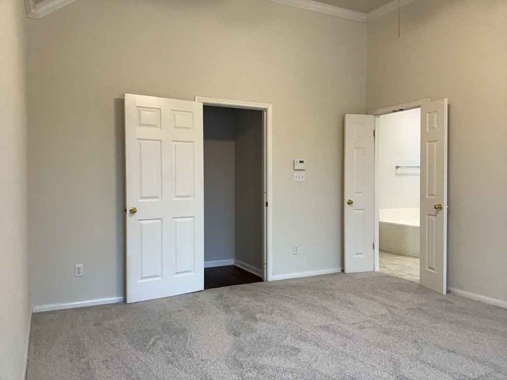 2013 Inverness Drive Round Rock, TX 78681 - Photo 16 of 26 Primary bedroom with carpet and en suite bathroom