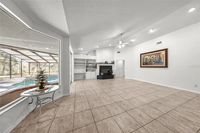 a view of a livingroom with a fireplace and window