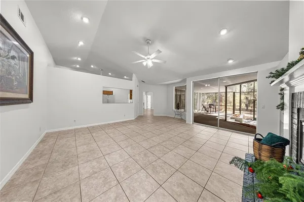 a view of an empty room with a window and a fan