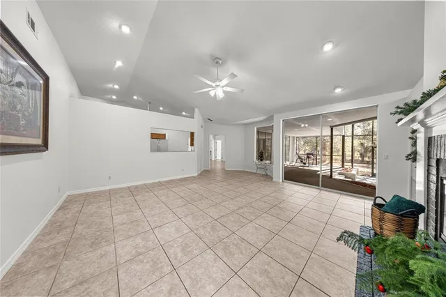 a view of an empty room with a window and a fan