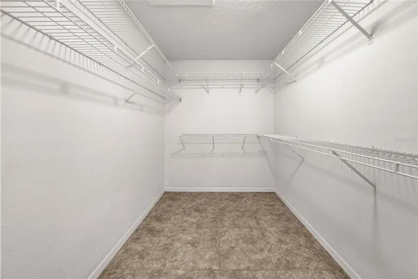 a large bathroom with a double vanity sink a large mirror and a bathtub