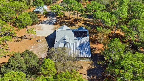 an aerial view of a house with a yard