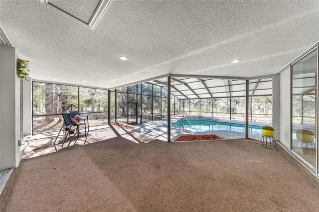 a living room with a large window and furniture