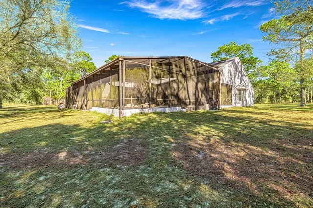 a view of an house with backyard space and balcony