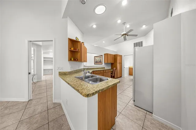 a kitchen with stainless steel appliances a refrigerator and cabinets