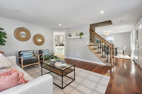 a living room with furniture and a wooden floor