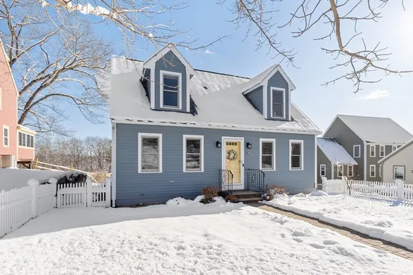 a view of a house with a snow in the background