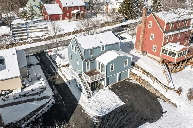 an aerial view of a house with a yard