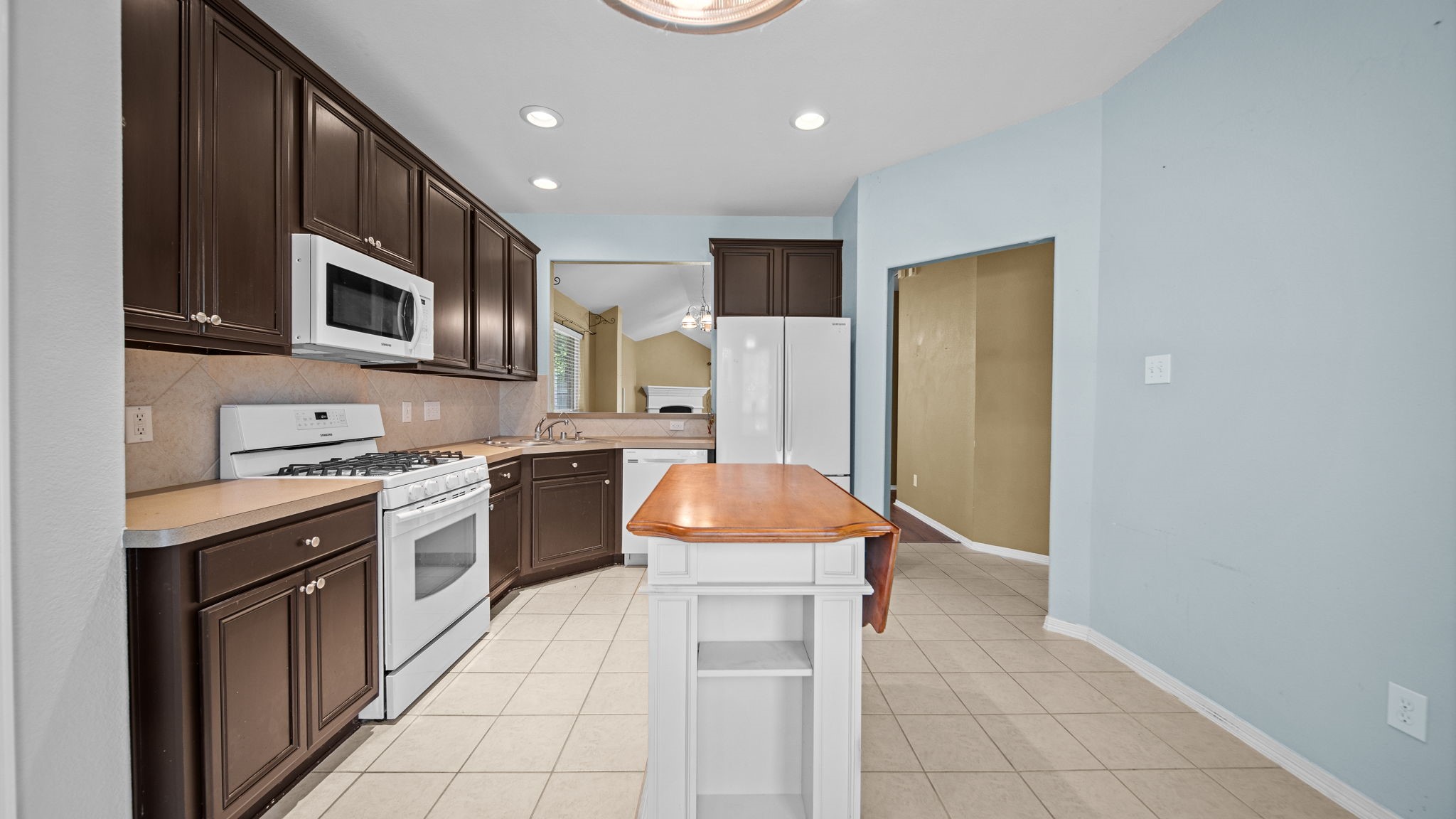 213 Mesa View Conroe, TX 77316 - Photo 7 of 19 a kitchen with stainless steel appliances granite countertop a refrigerator and a stove top oven