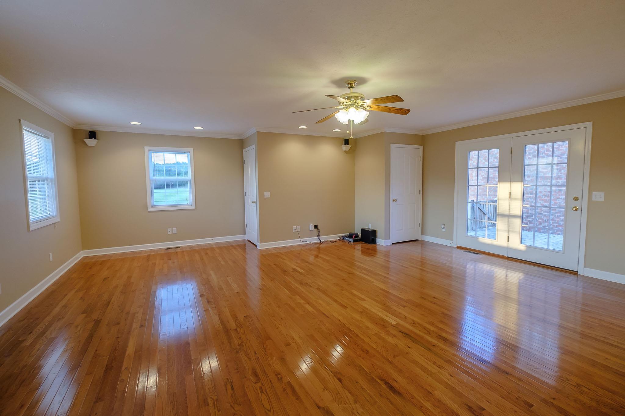 959 Wayside Road Manchester, TN 37355 - Photo 17 of 30 a view of an empty room with chandelier and wooden floor