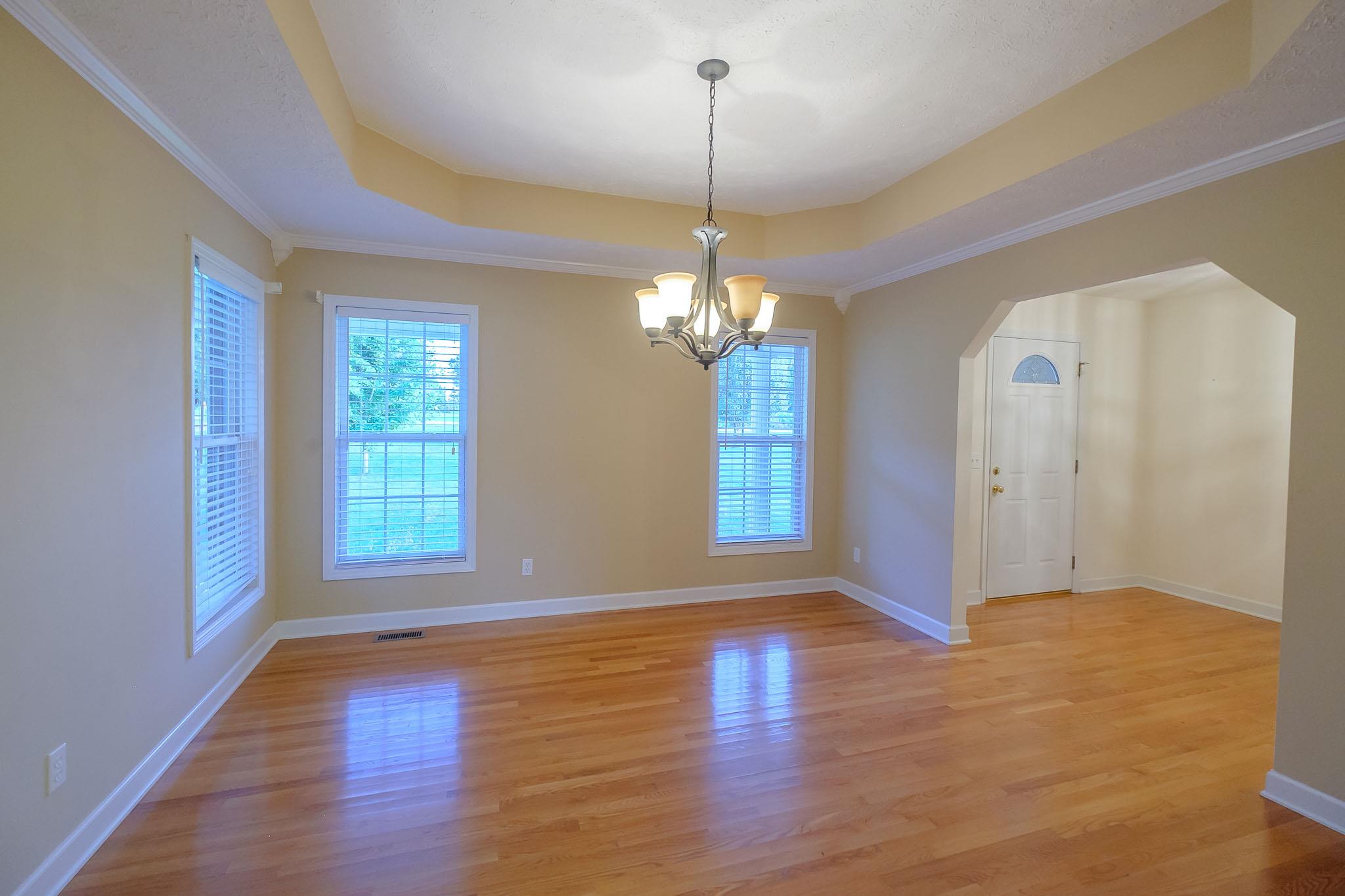 959 Wayside Road Manchester, TN 37355 - Photo 8 of 30 a view of an empty room with wooden floor and a window