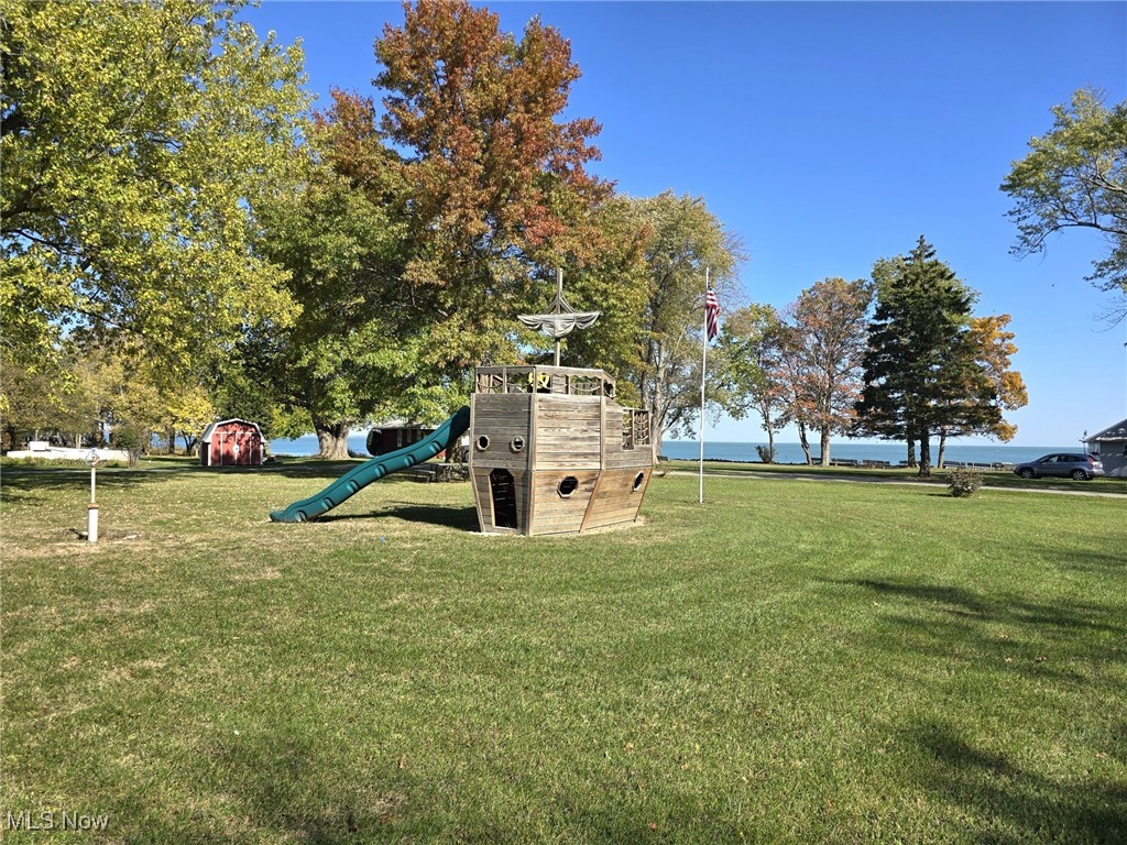 3575 Northeast Catawba Road, Unit 11 Port Clinton, OH 43452 - Photo 18 of 23 View of playground featuring a yard and a water view