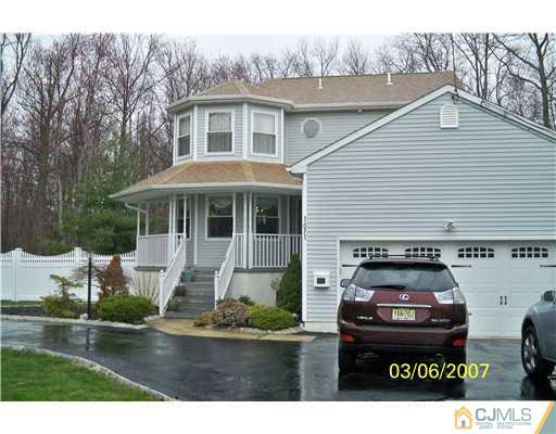1669 Union Avenue, Unit NONE Hazlet, NJ 07730 - Photo 1 of 10 a front view of a house with a garden and trees