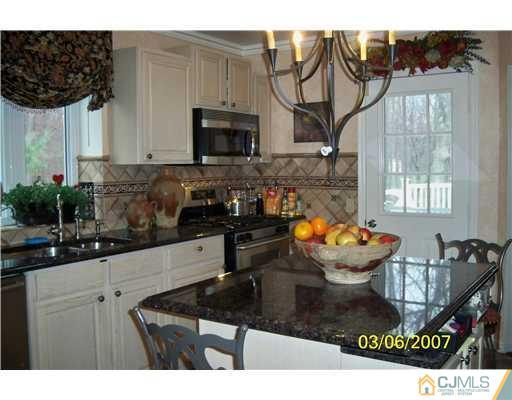 1669 Union Avenue, Unit NONE Hazlet, NJ 07730 - Photo 5 of 10 a kitchen with a sink a stove and a microwave